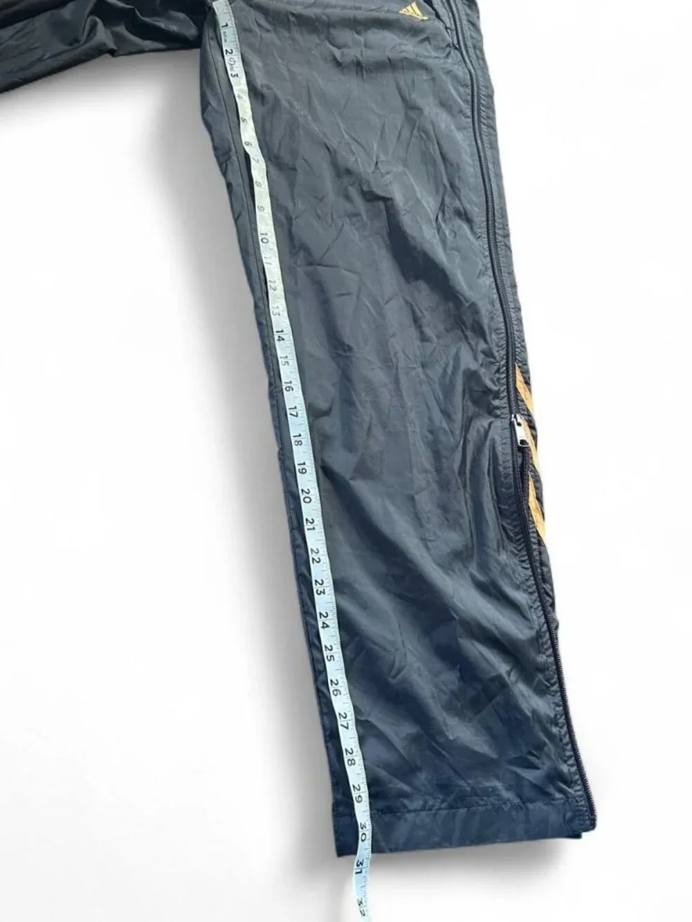 Adidas navy track pants with yellow stripes and zipper pockets size medium